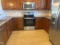 Modern kitchen with stainless steel appliances and ample cabinetry at 49 Danbury Ct, Pittsboro, NC 27312