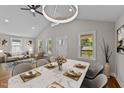 Bright dining area with marble table, stylish chandelier, and open to living area at 605 Quarry St, Raleigh, NC 27601
