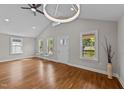 Inviting living area with hardwood floors, large windows, and modern lighting fixtures at 605 Quarry St, Raleigh, NC 27601