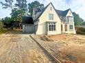 A beautiful new two-story home with an attached garage and unfinished gravel driveway at 217 Dublin Rd, Raleigh, NC 27609