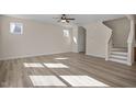 Bright living room featuring hardwood floors and a staircase at 211 Wild Turkey Way, Lillington, NC 27546