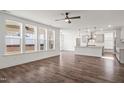 Open-concept living area and kitchen featuring hardwood floors and abundant natural light streaming through large windows at 3113 Petrea Ct # 38, Angier, NC 27501