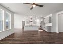 Open-concept living area and kitchen featuring hardwood floors, abundant natural light, and stylish modern fixtures at 3113 Petrea Ct # 38, Angier, NC 27501
