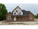 New two-story brick home under construction with a covered porch and an abundance of windows at 6352 River Rd, Fuquay Varina, NC 27526