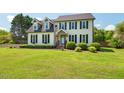 Charming two-story home with a well-manicured lawn and inviting front porch at 135 Deep Creek, Rougemont, NC 27572