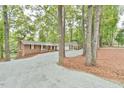 Beautiful home with brick and white siding, accented by a spacious gravel driveway and mature trees at 128 Dixie Dr, Chapel Hill, NC 27514