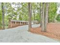 Two-toned home with a gravel driveway and lush landscaping at 128 Dixie Dr, Chapel Hill, NC 27514