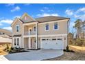 Elegant two-story home boasting a cozy balcony, a two-car garage, and charming curb appeal at 3109 Petrea Ct # 39, Angier, NC 27501