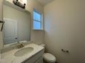 Powder room includes a granite vanity top and updated lighting at 490 Traditions Grande Blvd # 27, Wake Forest, NC 27587
