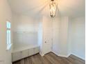 A bright mudroom features built-in storage, hooks and hardwood floors at 9229 Kitchin Farms Way # 427, Wake Forest, NC 27587