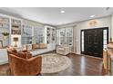 Cozy living room featuring hardwood floors and built-in shelving at 220 Clubhouse Dr, Youngsville, NC 27596