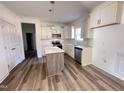 Modern kitchen with white cabinets, an island, and stainless steel appliances at 64 Lupin Dr, Smithfield, NC 27577