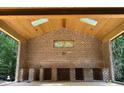 Spacious outdoor kitchen features brick facade, wood ceiling, and built-in shelving at 67 Ridgeline Ct # 7, Pittsboro, NC 27312