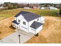 Aerial view of the new construction home with a three-car garage and a long driveway at 7417 Prato Ct, Wendell, NC 27591