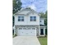 Two-story house with white siding, stone accents, and a two-car garage at 211 Hopewell Branch Ct, Smithfield, NC 27577