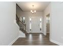 Welcoming foyer with hardwood floors, a staircase with iron railings, and a chandelier at 225 Hopewell Branch Ct, Smithfield, NC 27577
