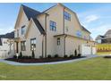 Beautiful home featuring attached garage, stone accents, green lawn, and attractive landscaping at 2525 Silas Peak Ln, Apex, NC 27523