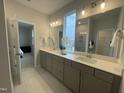 Bathroom featuring double vanity sinks with large mirrors, recessed lighting, and neutral tones at 321 Murray Grey Ln, Wake Forest, NC 27587