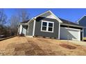 Charming one-story home featuring a gray exterior, white trim, and an attached one-car garage at 29 Longdale Dr, Graham, NC 27253