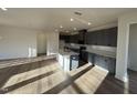 Modern kitchen featuring gray cabinets, white countertops, stainless steel appliances, and a center island at 29 Longdale Dr, Graham, NC 27253