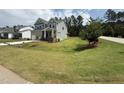 View of a two-story home with a large, green lawn at 135 Green Haven Blvd # 1, Youngsville, NC 27596