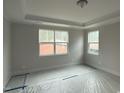 This neutral bedroom has tray ceiling and plenty of natural light at 145 Green Haven Blvd # 83, Youngsville, NC 27596
