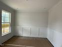 This dining room has chair railing, neutral paint and a bright window at 145 Green Haven Blvd # 83, Youngsville, NC 27596