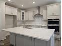 Bright kitchen featuring a large island, stainless steel appliances, and sleek cabinetry at 145 Green Haven Blvd # 83, Youngsville, NC 27596