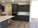 Modern kitchen with dark cabinetry and quartz countertops at 508 Glenwyck Ct, Fuquay Varina, NC 27526