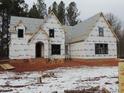 Two-story house under construction, brick exterior, covered porch, snow on ground at 1207 Red Cedar Court, Youngsville, NC 27596