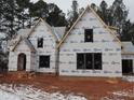Two-story house under construction, brick exterior, covered porch, snow on ground at 1207 Red Cedar Court, Youngsville, NC 27596