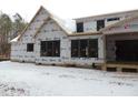 Rear view of house under construction, large windows, house wrap at 1207 Red Cedar Court, Youngsville, NC 27596