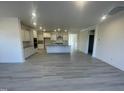 Elegant kitchen featuring white cabinetry, stainless steel appliances, and a functional center island open to living space at 1504 Maelyn Way, Fuquay Varina, NC 27526