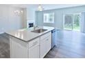Open-concept kitchen with stainless appliances, granite countertops, island, and direct access to the backyard at 727 Putney Hill Rd, Zebulon, NC 27597
