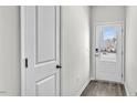 Welcoming entryway with a sturdy wooden door, modern lock, and light gray walls at 1304 Jasmine View Way, Knightdale, NC 27545