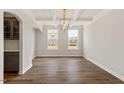 Bright dining room with wood floors, coffered ceilings, and built-in cabinetry at 80 Bold Dr, Youngsville, NC 27596