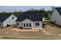 Home exterior and backyard awaiting landscaping shows the patio and view of the house at 1056 Fairhaven Dr # 97, Mebane, NC 27302