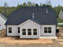 Backyard view of the new home construction shows the backyard patio and black roof at 1056 Fairhaven Dr # 97, Mebane, NC 27302