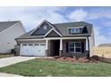 Charming single-story brick home featuring a two-car garage and well-maintained lawn at 1056 Fairhaven Dr # 97, Mebane, NC 27302