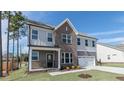 Attractive two-story home boasts a brick facade, covered porch, tidy landscaping, and a two-car garage at 1237 Jasmine View Way, Knightdale, NC 27545