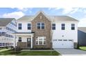 New two story construction featuring brick and light siding with an attached two car garage at 512 Lemon Daisy Ln, Knightdale, NC 27545