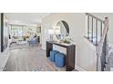 Inviting foyer with staircase, console table with decor, and an open view to the living room at 512 Lemon Daisy Ln, Knightdale, NC 27545