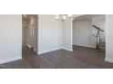 Open dining room with hardwood floors leading to stairs and other rooms at 524 Lemon Daisy Ln, Knightdale, NC 27545