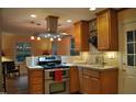 Updated kitchen with stainless steel appliances, stone countertops, and ample cabinet space at 7610 Buckhorn Rd, Hillsborough, NC 27278