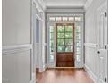 Bright entryway with hardwood floors and a wood door at 6720 Fawn Hoof Trl, Holly Springs, NC 27540