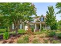 Two story house exterior with front porch and landscaping at 6720 Fawn Hoof Trl, Holly Springs, NC 27540
