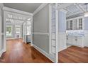 Hallway with hardwood floors and a view into the kitchen and dining area at 6720 Fawn Hoof Trl, Holly Springs, NC 27540