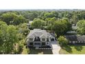 Expansive aerial view of a modern home surrounded by lush greenery and mature trees at 712 Daniels St, Raleigh, NC 27605