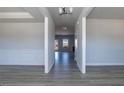 Bright hallway with modern gray flooring and neutral paint throughout a new home at 525 Glenkirk Pl, Garner, NC 27529