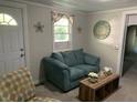 Living room with teal couch and coffee table at 709 W Horne St, Clayton, NC 27520